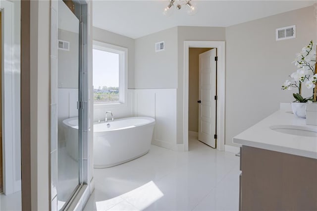 bathroom with vanity, plus walk in shower, and tile patterned floors