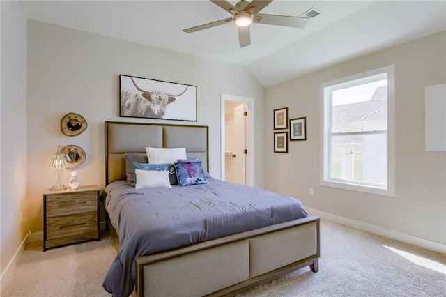 bedroom featuring lofted ceiling, light colored carpet, ceiling fan, and connected bathroom