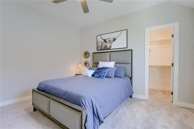 carpeted bedroom featuring a closet, ceiling fan, a spacious closet, and vaulted ceiling