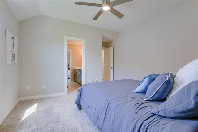 carpeted bedroom featuring lofted ceiling, ceiling fan, and ensuite bathroom