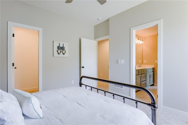 bedroom with carpet, ceiling fan, and connected bathroom