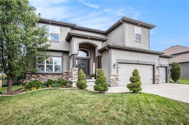 view of front of home featuring a front yard and a garage