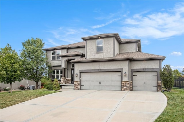 prairie-style home with a front yard and a garage