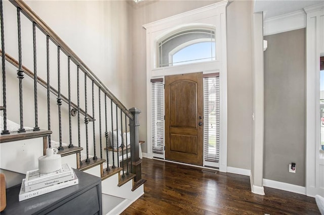 entryway with a healthy amount of sunlight, ornamental molding, and dark hardwood / wood-style floors