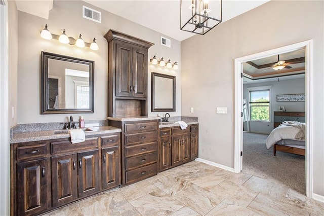 bathroom with ceiling fan with notable chandelier, vanity, and crown molding