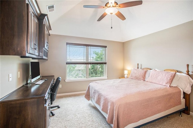 carpeted bedroom with ceiling fan and vaulted ceiling