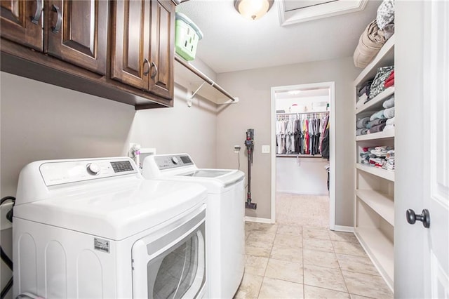 clothes washing area with independent washer and dryer and cabinets