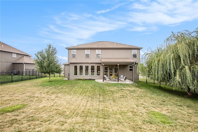 back of house with a patio and a yard