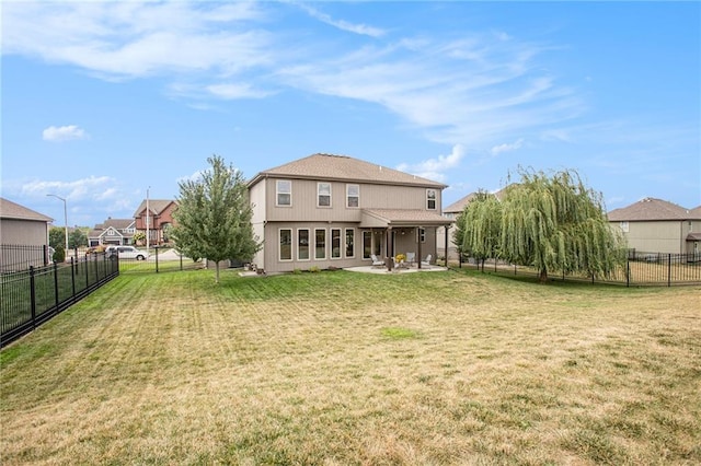 rear view of property with a patio and a yard