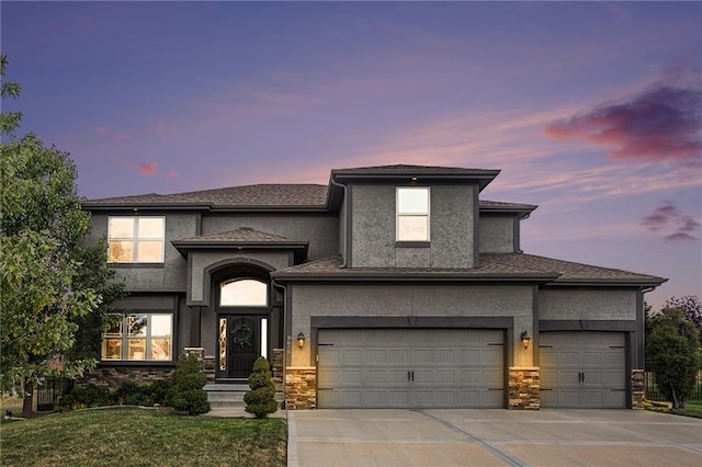 prairie-style home with a lawn and a garage