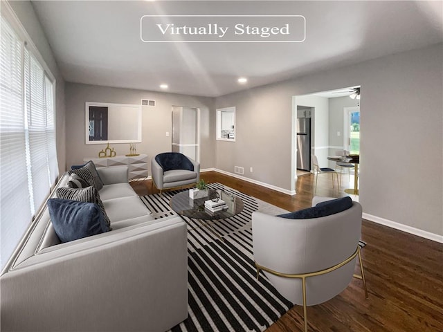 living room with a healthy amount of sunlight, ceiling fan, and hardwood / wood-style flooring