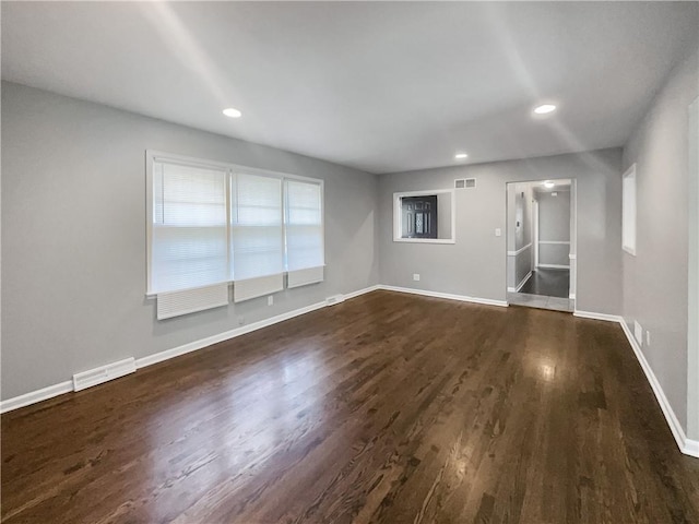 unfurnished living room featuring recessed lighting, visible vents, baseboards, and dark wood-style flooring