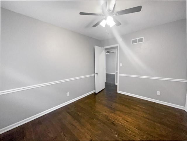 unfurnished bedroom with ceiling fan, wood finished floors, visible vents, and baseboards