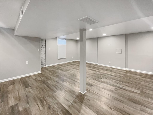 below grade area featuring visible vents, recessed lighting, wood finished floors, and baseboards