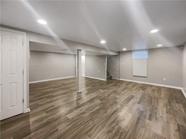 below grade area featuring baseboards and wood finished floors