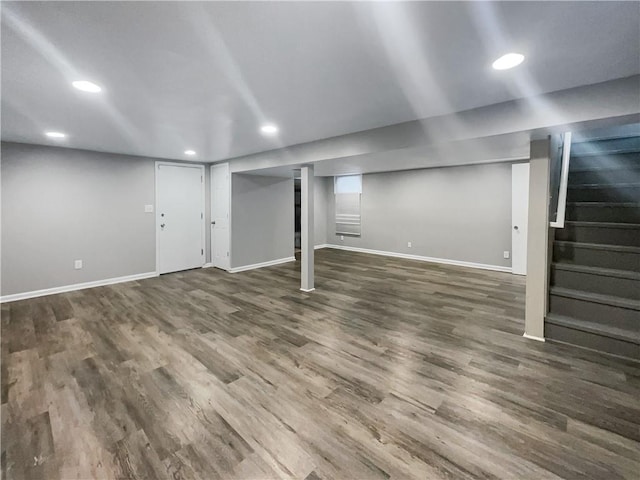 finished basement with recessed lighting, baseboards, wood finished floors, and stairs