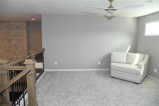 unfurnished room featuring a ceiling fan, carpet flooring, an upstairs landing, and baseboards