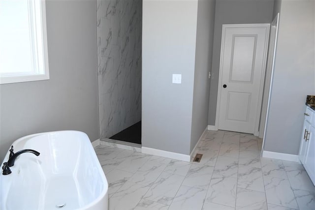 full bathroom with baseboards, marble finish floor, a freestanding bath, vanity, and a walk in shower