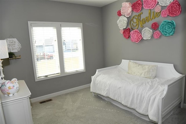 bedroom featuring light carpet, baseboards, and visible vents