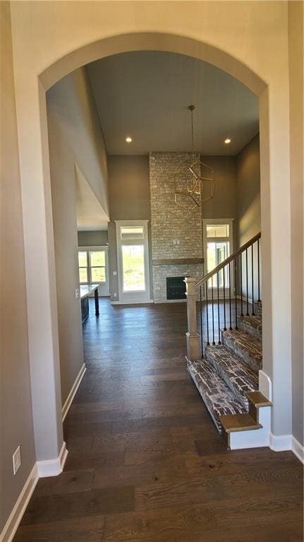 hallway featuring stairway, recessed lighting, dark wood finished floors, and baseboards