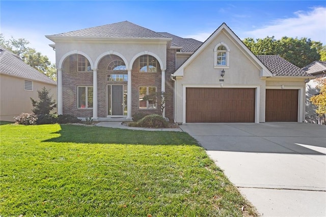 view of front facade with a garage and a front lawn