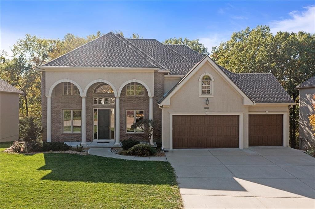 view of front of house with a front yard and a garage