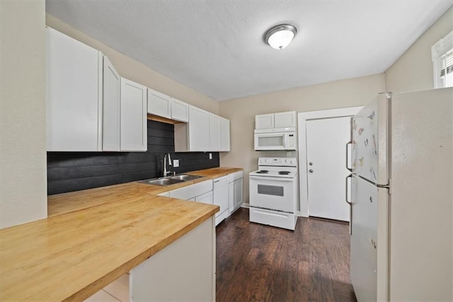 kitchen featuring white appliances, dark wood-style floors, wood counters, white cabinetry, and a sink