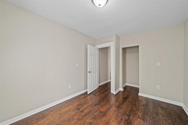 unfurnished bedroom with baseboards and wood finished floors