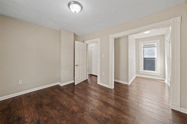 interior space with baseboards and wood finished floors