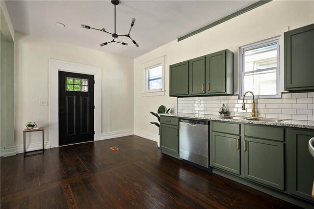 kitchen featuring stainless steel dishwasher, sink, green cabinetry, and dark wood-type flooring