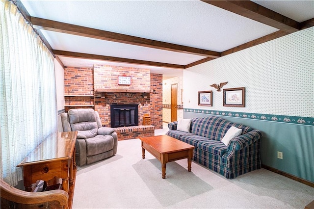 carpeted living room with a brick fireplace and beam ceiling