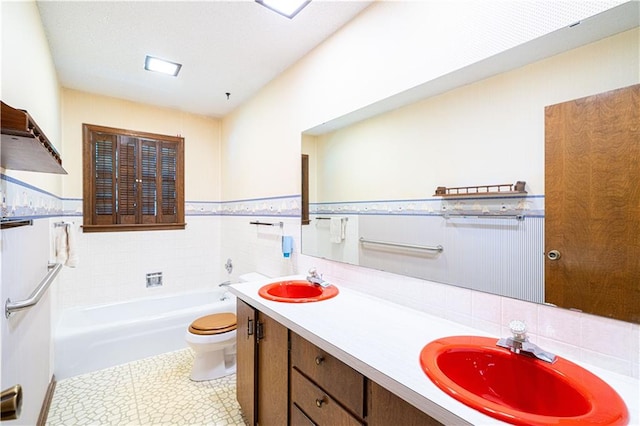 bathroom with vanity, a bath, tile walls, toilet, and tile patterned floors