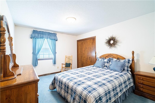 carpeted bedroom featuring a textured ceiling