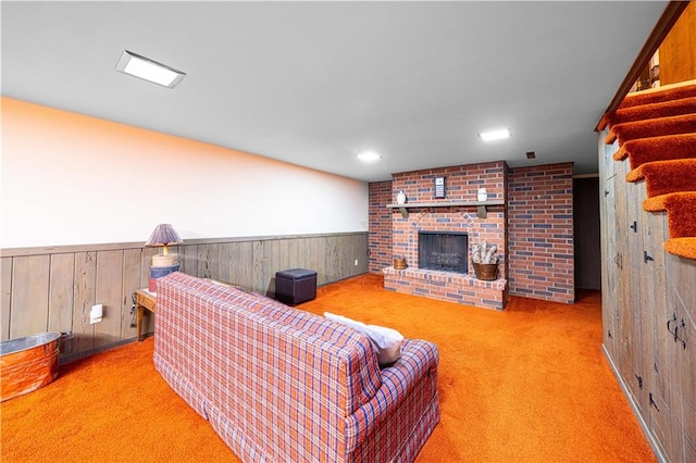 living room featuring wooden walls, carpet floors, and a fireplace