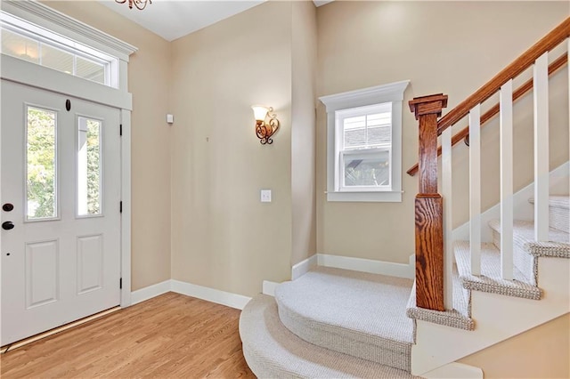 foyer entrance featuring a chandelier and light hardwood / wood-style floors