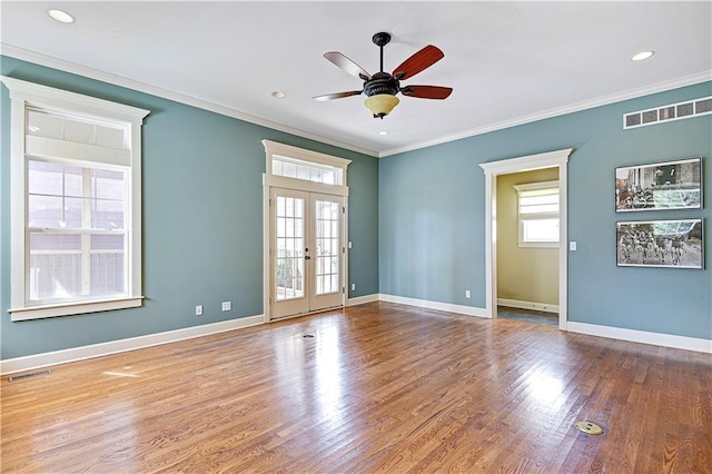 unfurnished room with ceiling fan, french doors, ornamental molding, and hardwood / wood-style flooring