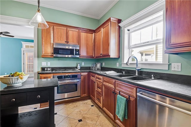 kitchen with ceiling fan, sink, hanging light fixtures, stainless steel appliances, and ornamental molding