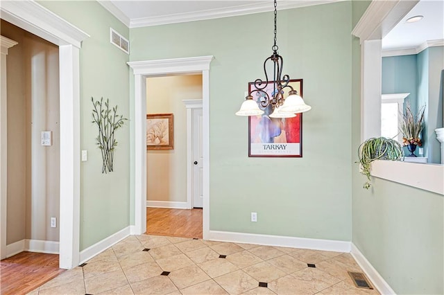 dining space featuring a notable chandelier, ornamental molding, and light hardwood / wood-style flooring