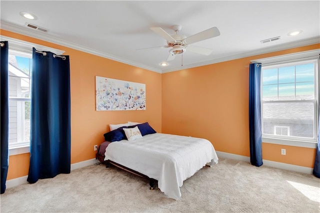 carpeted bedroom featuring multiple windows, ceiling fan, and crown molding