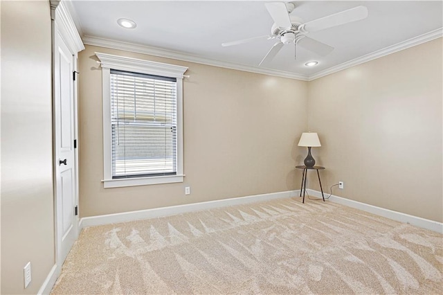 carpeted spare room featuring ceiling fan and ornamental molding