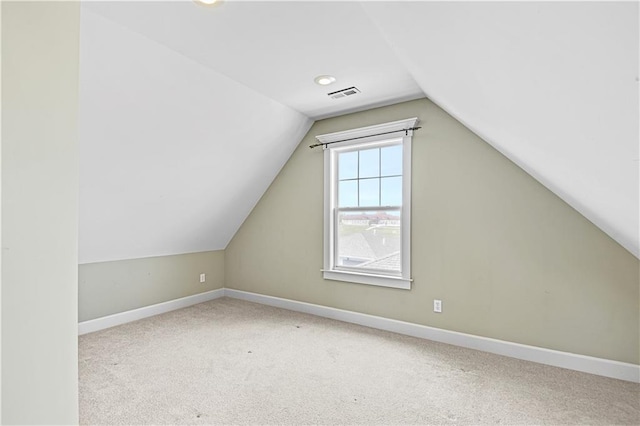 bonus room with carpet floors and vaulted ceiling