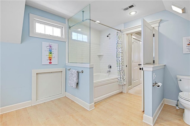 bathroom featuring shower / bath combination with curtain, vaulted ceiling, toilet, and hardwood / wood-style floors