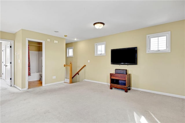 basement with light colored carpet and a wealth of natural light