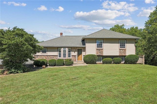 tri-level home with a front lawn