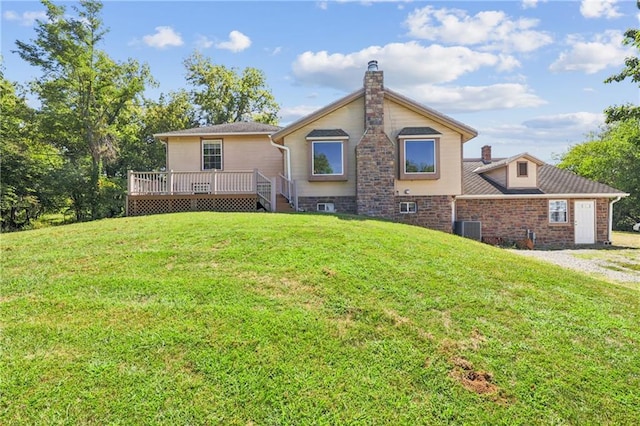 rear view of property with a deck and a lawn