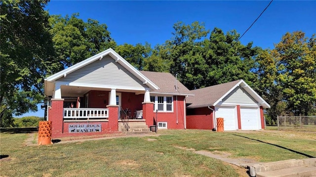 view of front of property with a garage, a front yard, and a porch