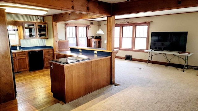 kitchen featuring decorative light fixtures, black appliances, light hardwood / wood-style floors, and a healthy amount of sunlight