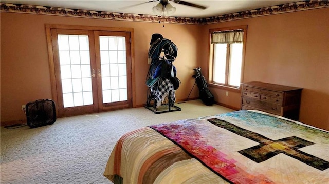 carpeted bedroom with multiple windows, french doors, and ceiling fan