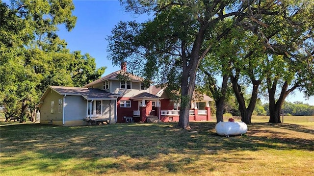 view of front facade with a deck and a front yard