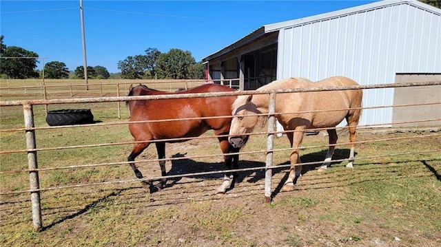 view of horse barn featuring a rural view